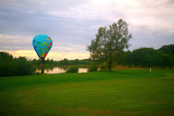 #caption-150 Hot air balloon landing on the course
